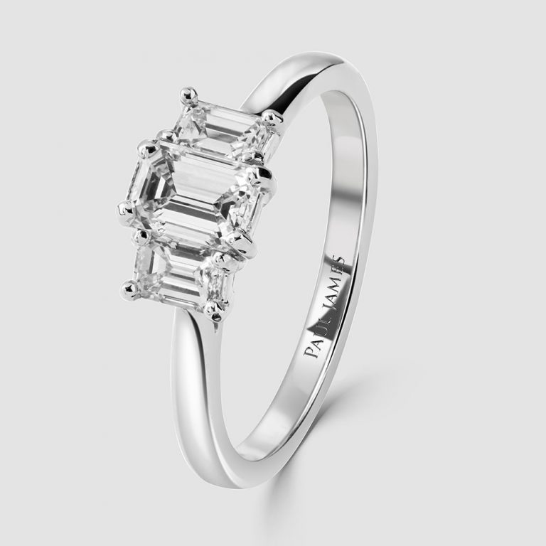 Emerald cut three stone diamond ring