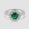 Platinum emerald and diamond halo ring
