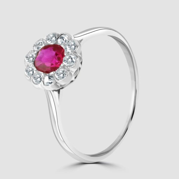 Ruby and diamond oval millgrain edge cluster ring