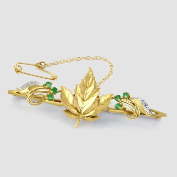 Maple leaf bar brooch with emeralds and diamonds